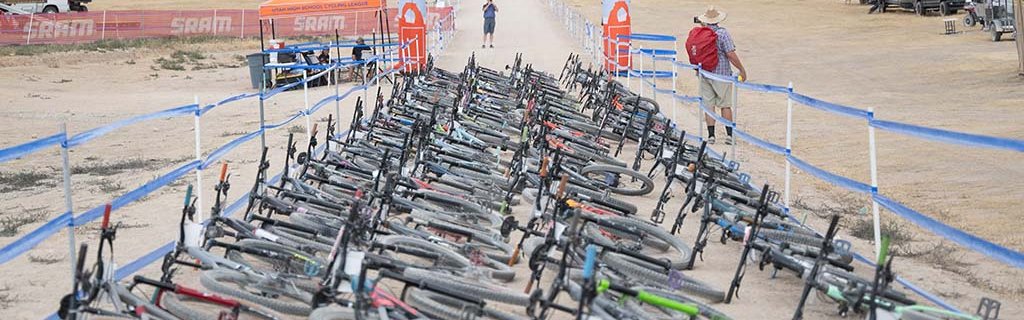 Mountain bikes lined up at the start line of a NICA race.